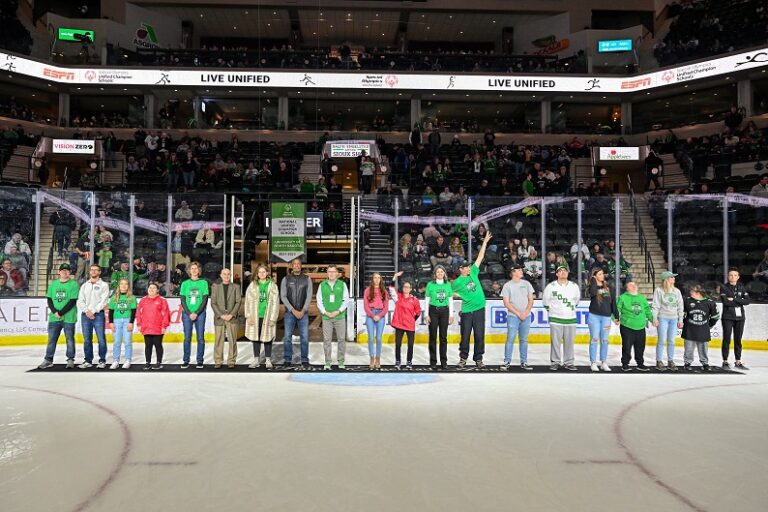 People standing on ice for national unified champion school recognition