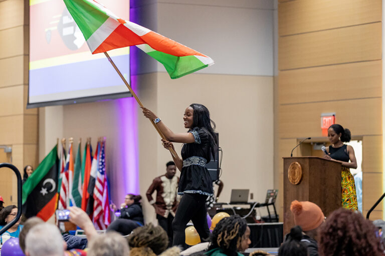 Person waving flag on stage