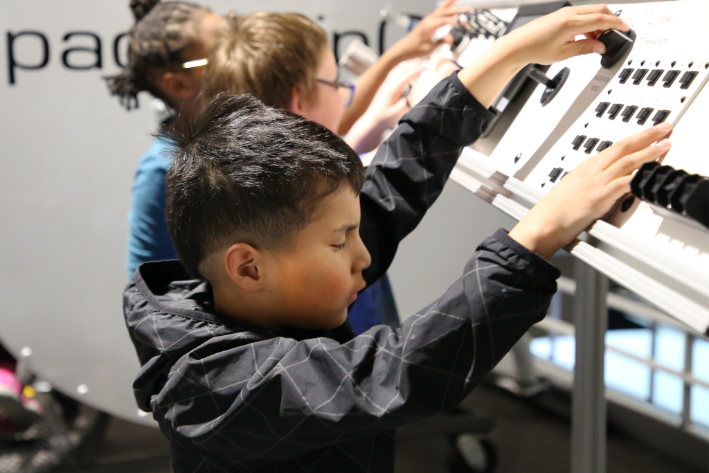 Student touching control panel