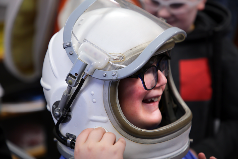 Student wearing space helmet