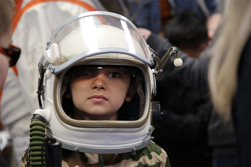 student in space helmet
