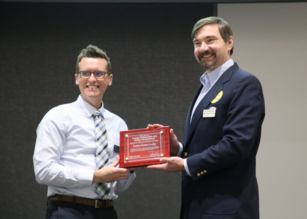 man hands another man award
