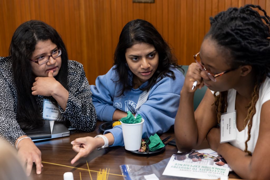 three students at table