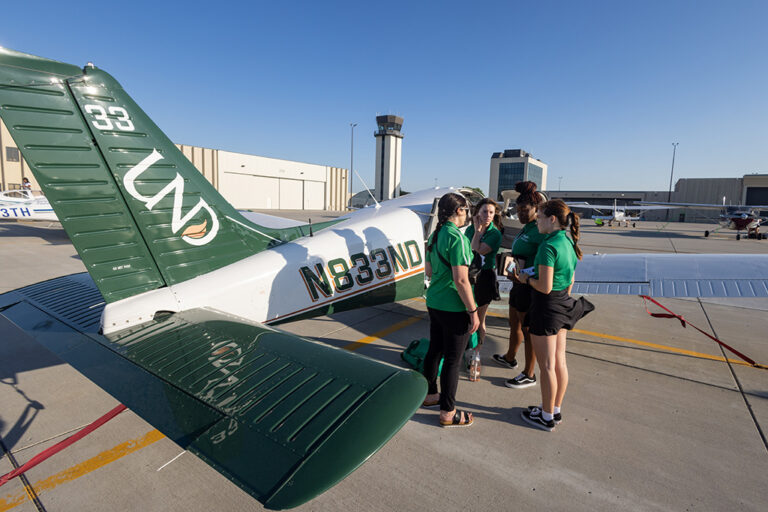 UND team next to aircraft