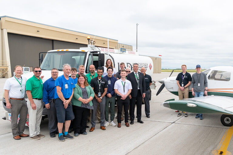 People standing in front of a fuel truck