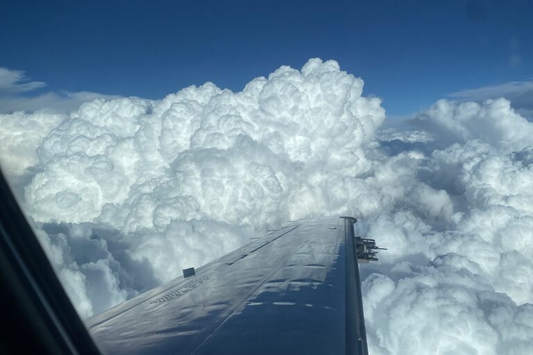 Clouds off tip of airplane wing