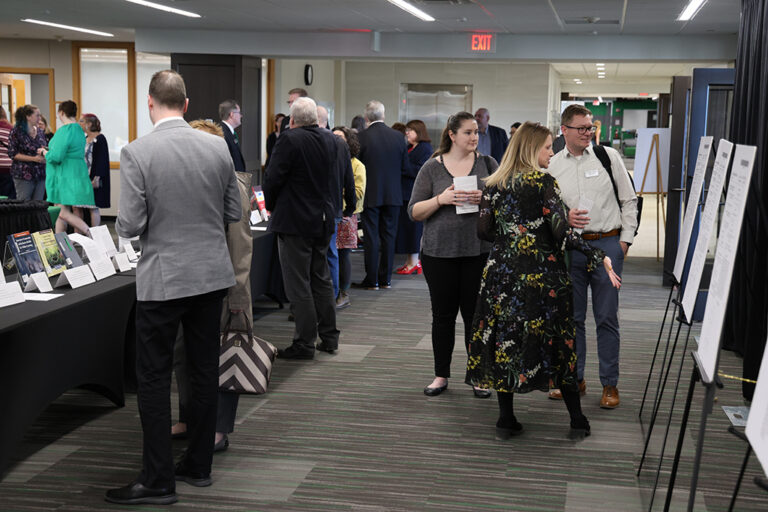Faculty looking at research displays