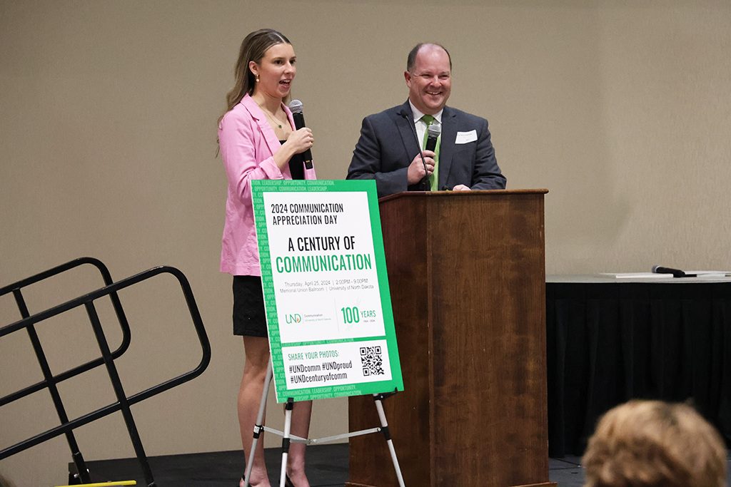 pair speaking at podium