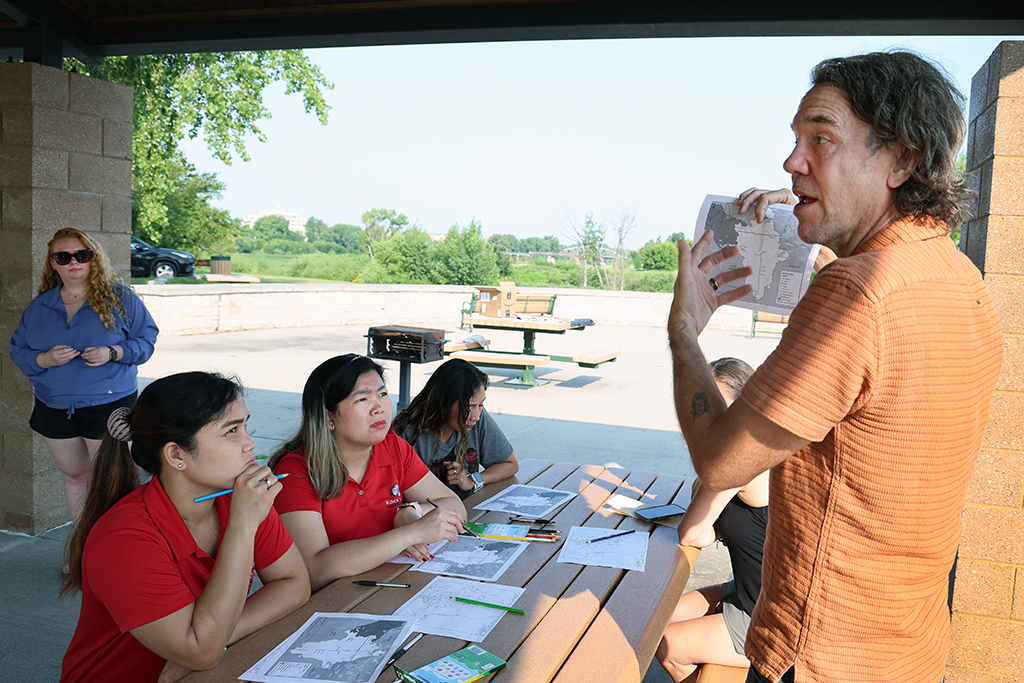 joshua hunter explains watershed map to project current teachers