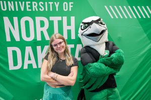 Student gets picture with Fighting Hawk