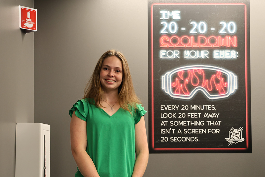 jasmine schmitz in front of poster