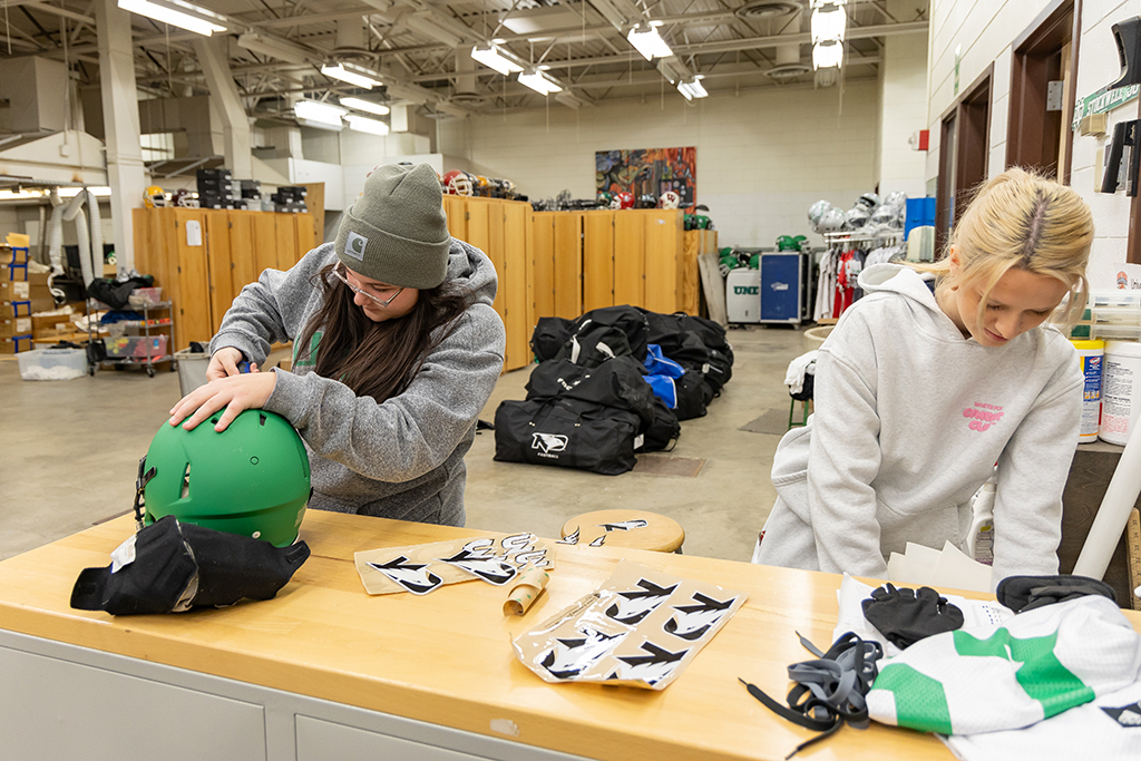 Students put decals on helmets