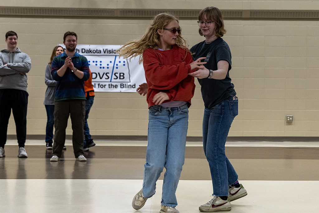 UND student and School for the Blind student do a swing dance together
