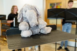 Stuffed elephant sits on music stand