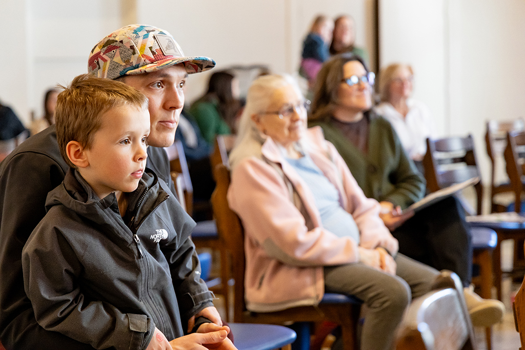 Man and young boy listen to music at sensory concert