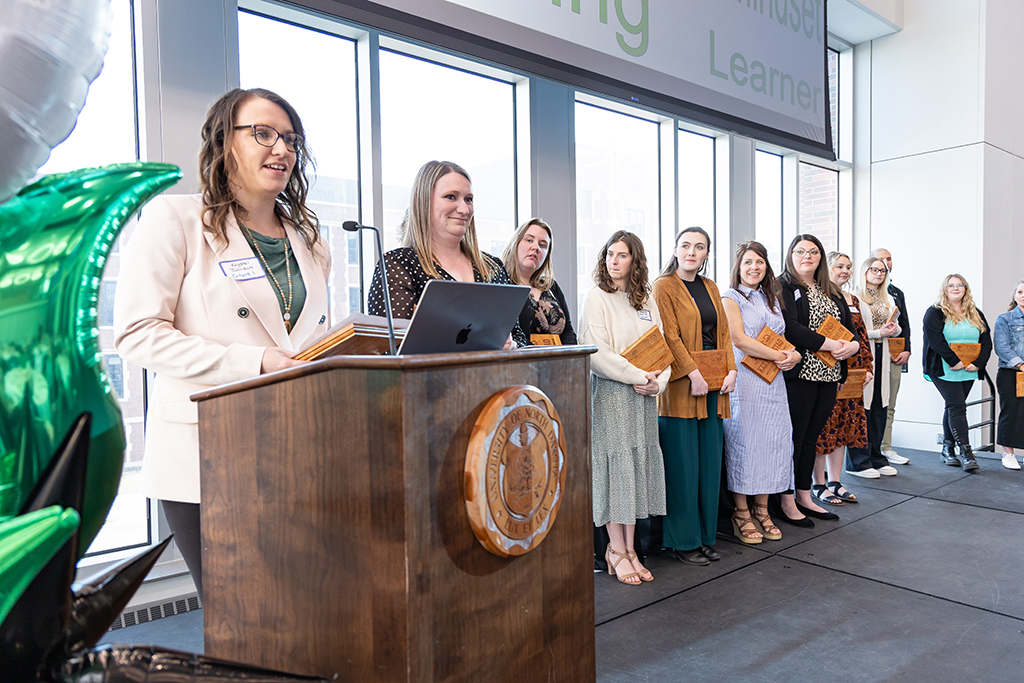 Krystal Johnson and other education partnership grad students on stage.