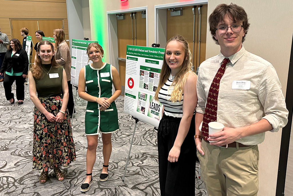 Students standing my their research poster
