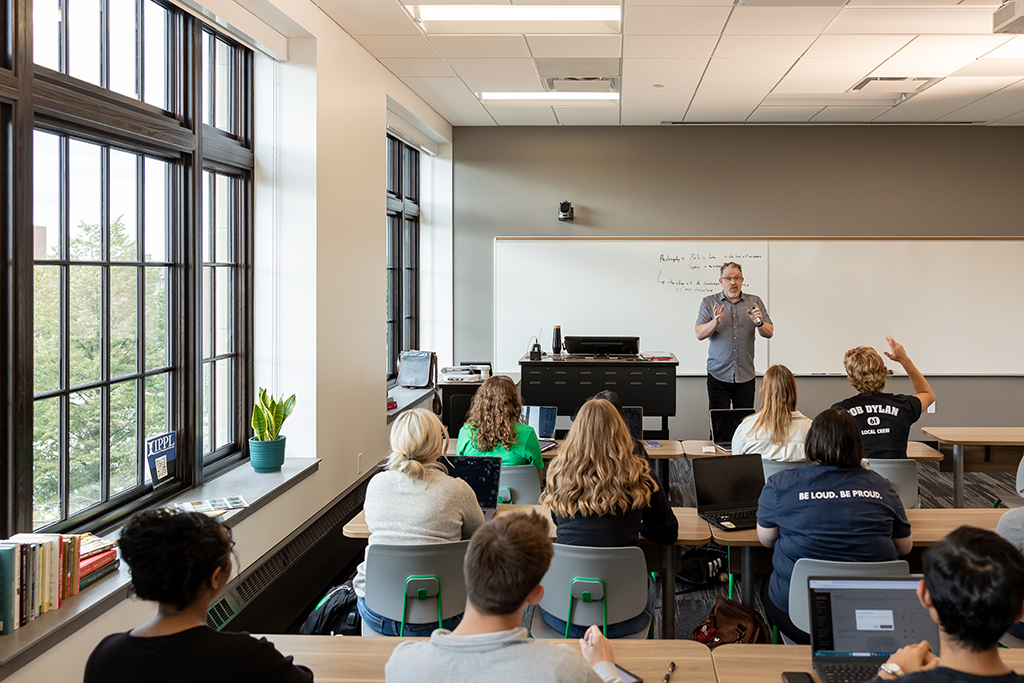 Professor at front of classroom addressing students