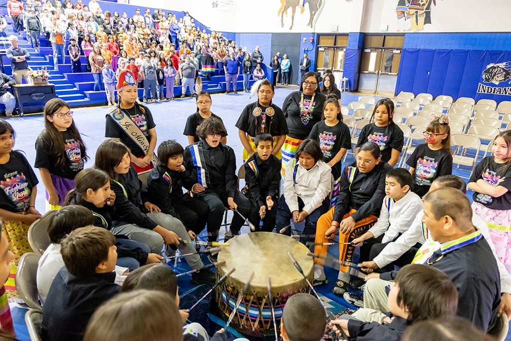 In Native tradition, boys and girls sing and drum at fashion show.