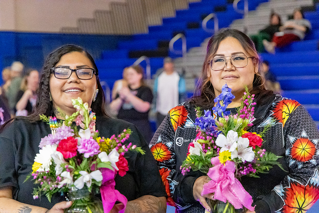 Honorees Leora Fox-White and Lorena Brown-Joshua hold flower bouquets.