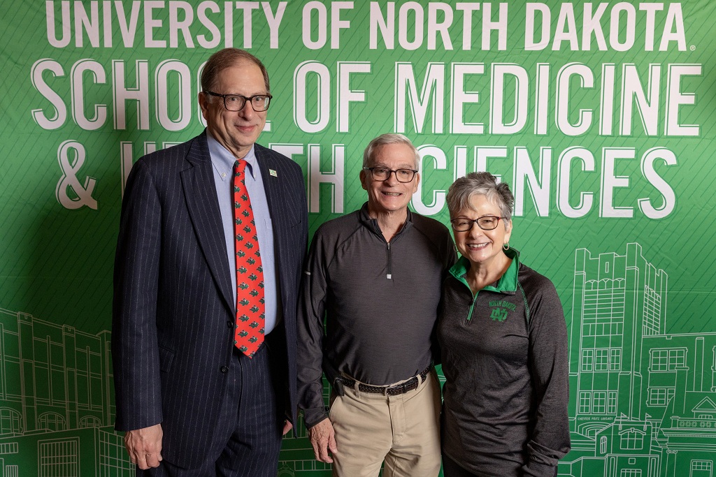Dr Joshua Wynne stands with Dr. Ron Tello and Dr. Tello's wife, Rebecca.