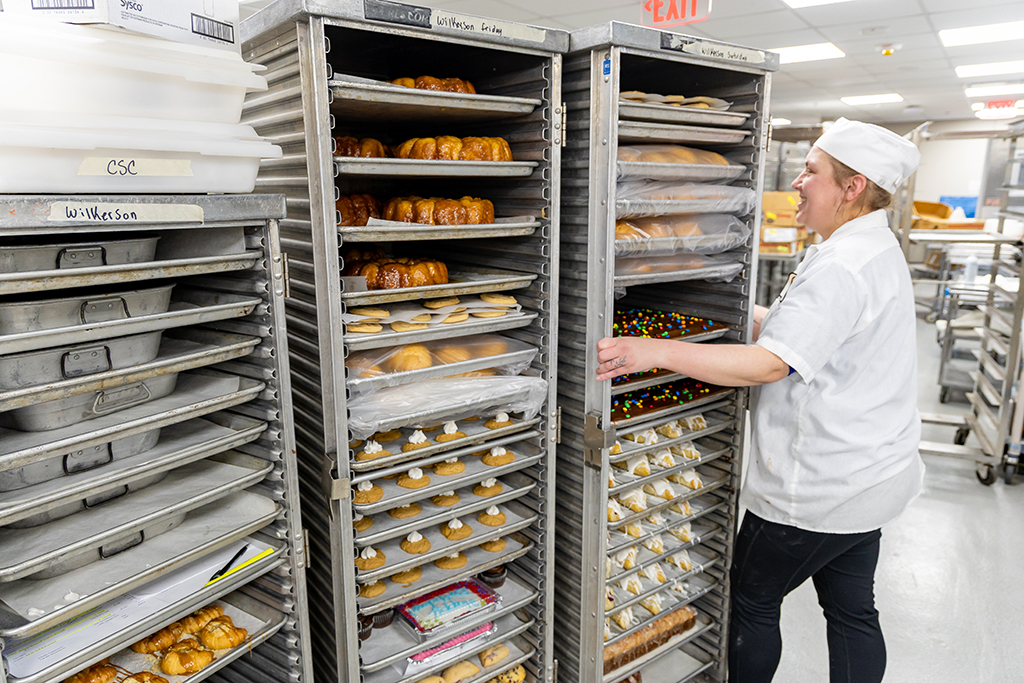 Bakery Manager Caylie Salge gets the carts ready to roll over to the Wilkerson Dining Center.