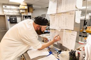 Mitch Vervalen makes notation on work order.