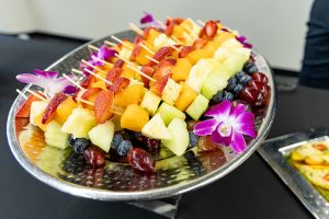 A platter of colorful fruit kebabs.