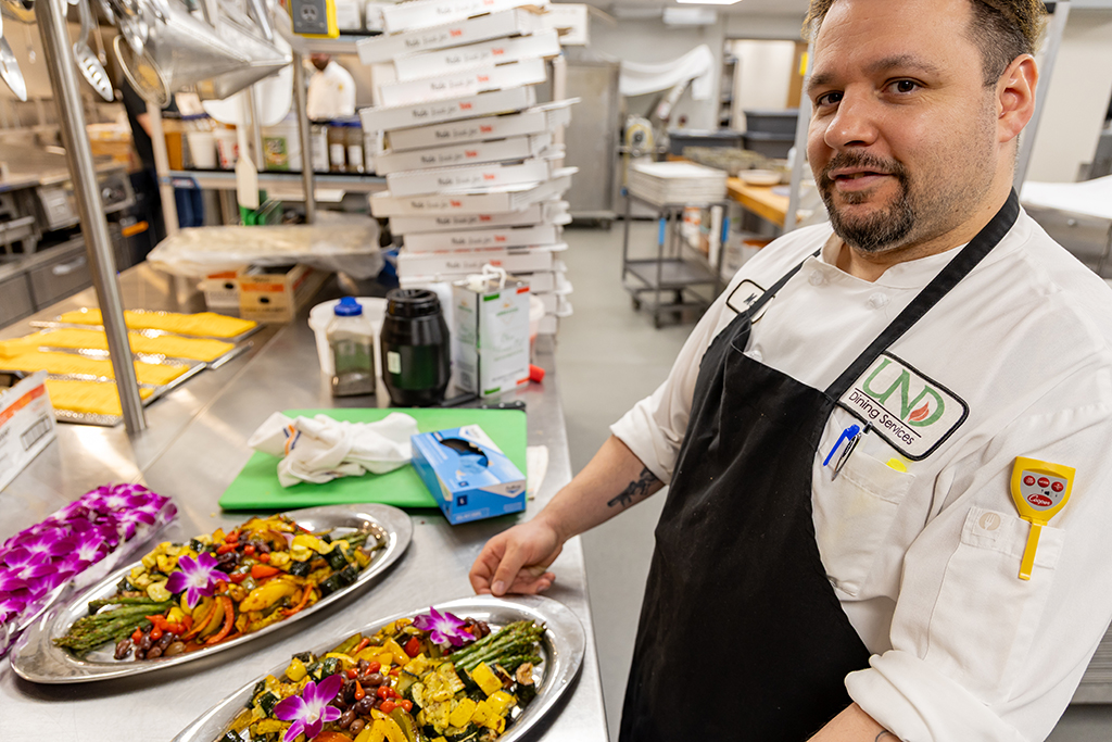 Lead Catering Chef Matt Fashingbauer puts the finishing touches on his trays of roasted vegetables.