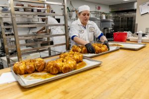 Bakery Manager Caylie Salge works with the fresh Monkey Bread. 