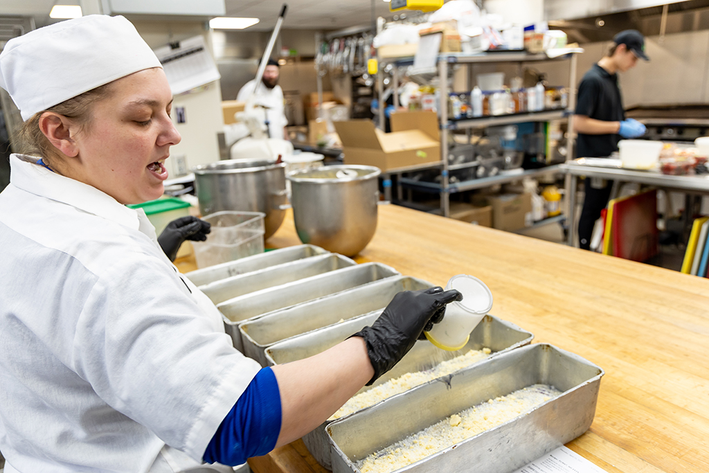 UND Bakery Manager Caylie Salge goes about her work while being interviewed at the same time.