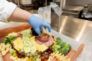 Catering Chef Micheal Longwell inverts the glass to complete the salami rosette.