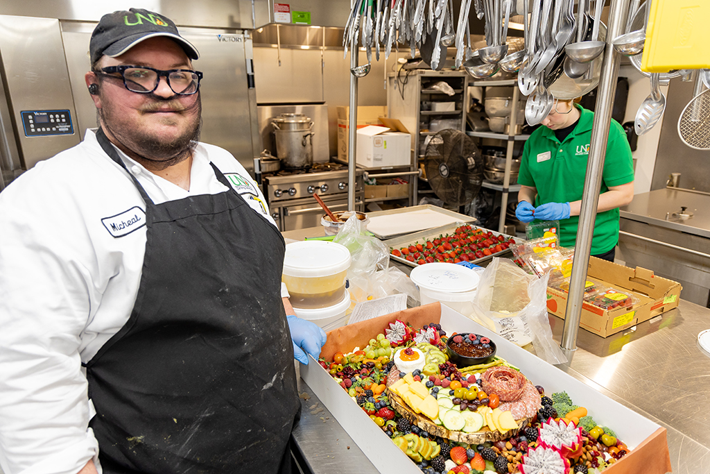 Catering Chef Micheal Longwell completes the core centerpiece for the grand charcuterie table.
