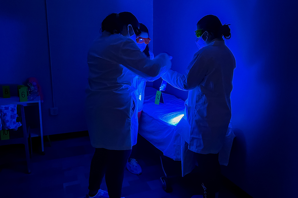 UND Forensic Science students collect evidence at mock crime scene.