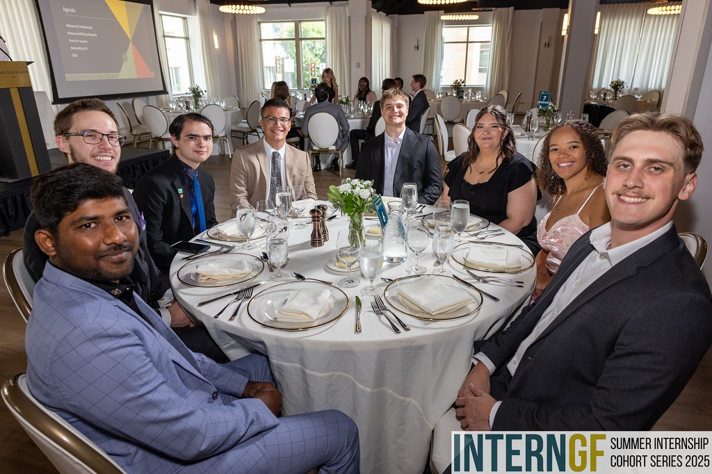 Participants at the 2025 InternGF Closing Celebration sitting at a table
