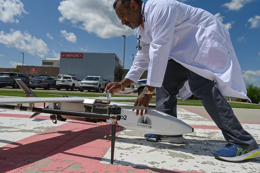 Dr. Ben Kazim retrieves medical supplies from a drone in connection with Project Rural Reach.