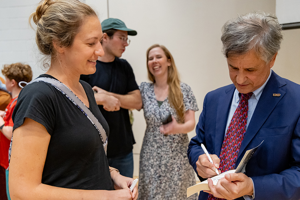 Dr. Daniel Levitin signs his book for a guest.