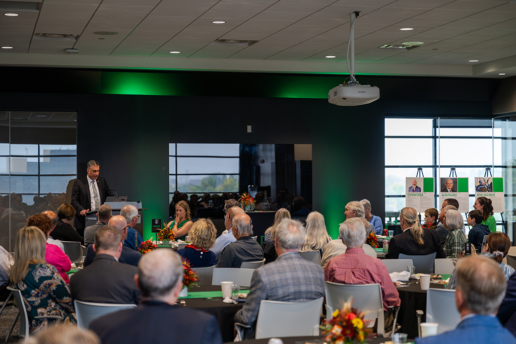 Bob Kraus speaking to audience from podium