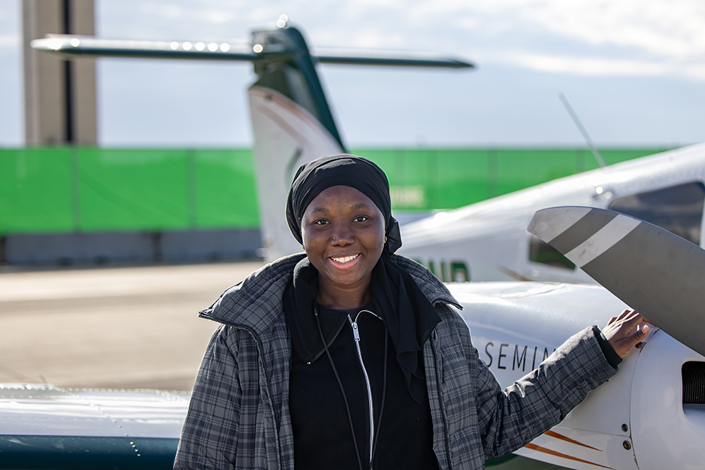 Noumousso Diane stands with plane.