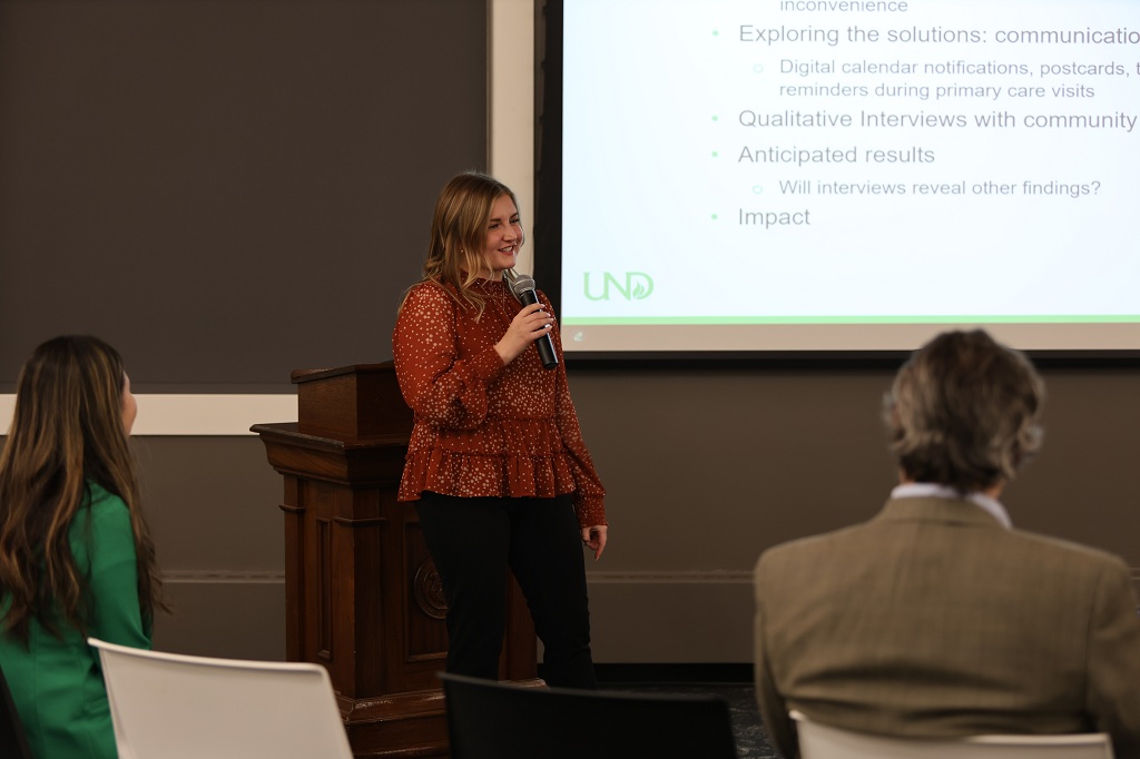 Graduate student Sydney Rea presents as part of Soojung Kim's Randy Rasmussen Lecture in Chester Fritz Library