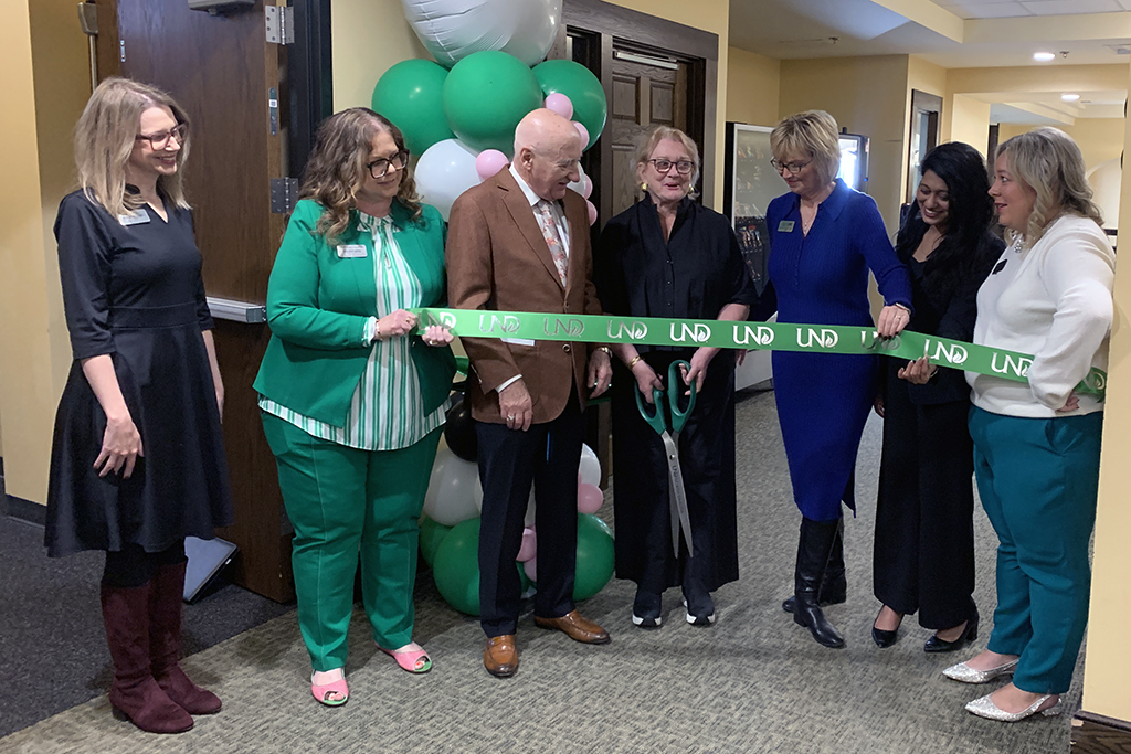 Kathleen Gershman gets ready to cut the ribbon at the grand re-opening of the student lounge space that bears her name.