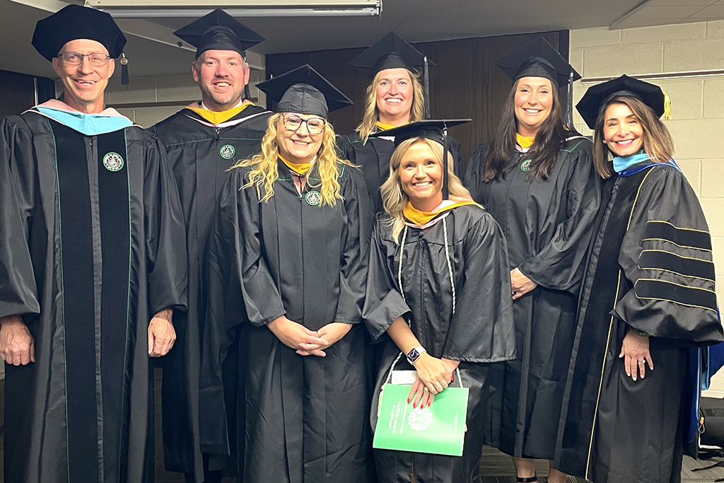 Aspiring principals graduate from the UND Master of Science in Teaching & Leadership with K-12 Principal Credential eligibility. The graduates include (from second on left) Dave Muhonen, Amanda Fuller, Amber Basting, Emily Schaefer and Heather Robideaux. They are flanked by Joel Schleicher (left), clinical assistant professor in Teaching & Leadership, and Laura Link, associate professor in Teaching & Leadership and director of the Master of Science in Teaching & Leadership/Mastery Learning Graduate Certificate program.