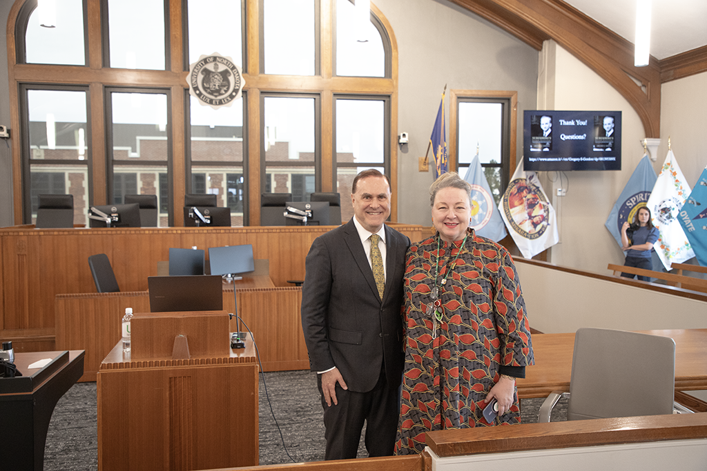gordon gordon and kimberly dasse stand in the vandewalle courtroom