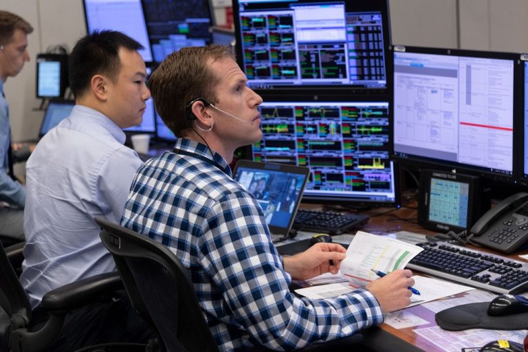Jeremy Raush sits at a computer console in NASA's Mission Control in Houston.