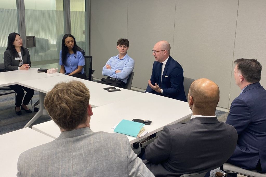 UND students sit with UND alums around a conference table in Washington
