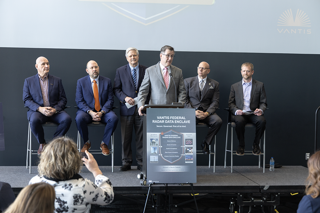 UND President Andy Armacost, center, with Sen. John Hoeven and others address a crowd at UND