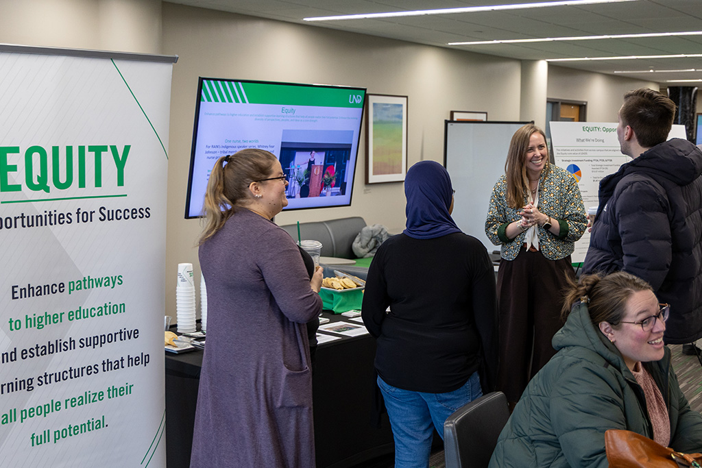 Anna Kinney speaking in front of a poster