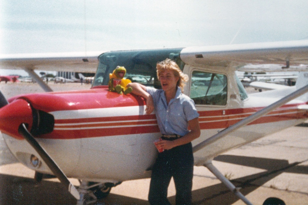 1981 photo of Jill Newby by a UND trainer plane.