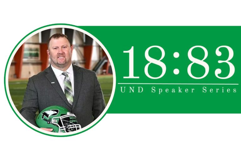 Headshot of Eric Schmidt holding football helmet with text: 18:83 speaker series