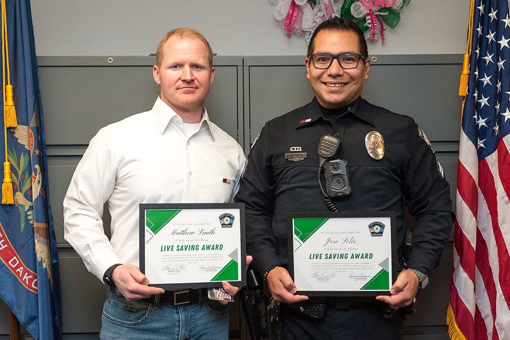 two people posing with awards.